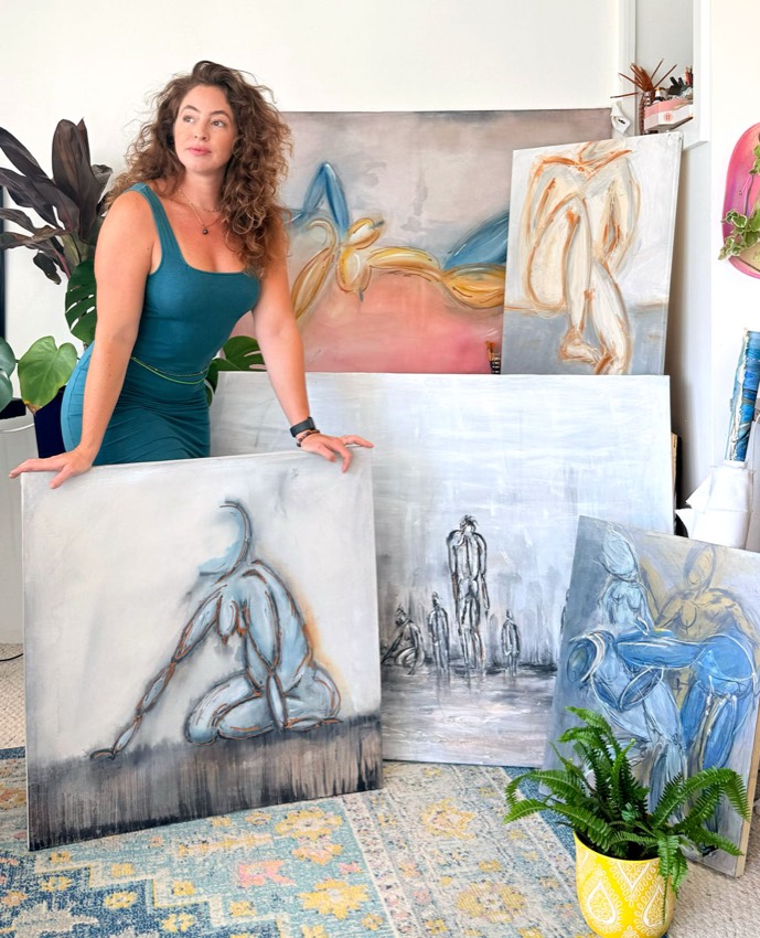 Michelle Jean in the studio with the figure paintings